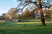 COTTESBROOKE HALL AND GARDENS, NORTHAMPTONSHIRE: SPRING, APRIL, TREES, PARKLAND, THE MITCHELL BRIDGE