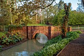 COTTESBROOKE HALL AND GARDENS, NORTHAMPTONSHIRE: SPRING, APRIL, THE WILD GARDEN, SMALL BROOK, STREAM, BRIDGE