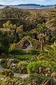 TRESCO ABBEY GARDEN, ISLES OF SCILLY: THE OLD ABBEY RUINS SEEN FROM THE TOP TERRACE, MAY, SPRING