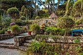 TRESCO ABBEY GARDEN, ISLES OF SCILLY: MAY, SPRING, VIEW TO THE SHELL HOUSE, TERRACING, STEPS
