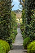 TRESCO ABBEY GARDEN, ISLES OF SCILLY: VIEW FROM TOP TERRACE ALONG NEPTUNE STEPS TO LIGHTHOUSE WALKS TO THE TRESCO CHILDREN SCULPTURE