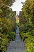 TRESCO ABBEY GARDEN, ISLES OF SCILLY: VIEW FROM TOP TERRACE ALONG NEPTUNE STEPS TO LIGHTHOUSE WALKS TO THE TRESCO CHILDREN SCULPTURE