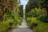 TRESCO ABBEY GARDEN, ISLES OF SCILLY: VIEW FROM TOP TERRACE ALONG NEPTUNE STEPS TO LIGHTHOUSE WALKS TO THE TRESCO CHILDREN SCULPTURE