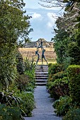 TRESCO ABBEY GARDEN, ISLES OF SCILLY: VIEW FROM TOP TERRACE ALONG NEPTUNE STEPS TO LIGHTHOUSE WALKS TO THE TRESCO CHILDREN SCULPTURE