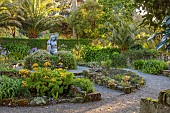 TRESCO ABBEY GARDEN, ISLES OF SCILLY: MAY, SPRING, GAIA SCULPTURE BY DAVID WYNNE, PALMS