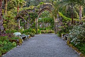TRESCO ABBEY GARDEN, TRESCO,  ISLES OF SCILLY: MAY, SPRING, THE OLD ABBEY - WOODEN BENCH AND OLD ABBEY RUINS