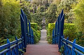 RESCO ABBEY GARDEN, TRESCO,  ISLES OF SCILLY: MAY, SPRING, THE BLUE WOODEN BRIDGE, VIEW TO MEDITERRANEAN GARDEN AND SHELL HOUSE