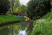 COTTESBROOKE HALL AND GARDENS, NORTHAMPTONSHIRE: SPRING, MAY: THE WILD GARDEN, STREAM, BRIDGE