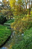 COTTESBROOKE HALL AND GARDENS, NORTHAMPTONSHIRE: SPRING, MAY: THE WILD GARDEN, STREAM, WILLOW, BRIDGE