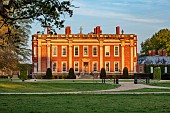 COTTESBROOKE HALL AND GARDENS, NORTHAMPTONSHIRE: SPRING, MAY: THE WEST FRONT OF THE HALL AT SUNSET