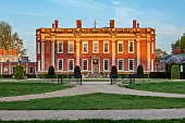 COTTESBROOKE HALL AND GARDENS, NORTHAMPTONSHIRE: SPRING, MAY: THE WEST FRONT OF THE HALL AT SUNSET