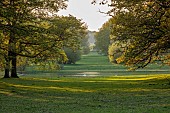 COTTESBROOKE HALL AND GARDENS, NORTHAMPTONSHIRE: SPRING, MAY: VIEW FROM THE WEST FRONT AT SUNSET, LAKE, TREES, PARKLAND