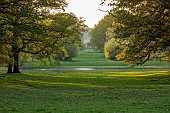 COTTESBROOKE HALL AND GARDENS, NORTHAMPTONSHIRE: SPRING, MAY: VIEW FROM THE WEST FRONT AT SUNSET, LAKE, TREES, PARKLAND