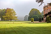 COTTESBROOKE HALL AND GARDENS, NORTHAMPTONSHIRE: SPRING, MAY: THE WEST FRONT, MIST, FOG, LAWN, PARKLAND