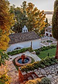 KOULOURA, CORFU, GREECE: DESIGNER PAUL BANGAY: TOP TERRACE, WATER FEATURE, LAWN, CHURCH, SUNRISE