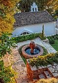 KOULOURA, CORFU, GREECE: DESIGNER PAUL BANGAY: TOP TERRACE, WATER FEATURE, LAWN, CHURCH, SUNRISE