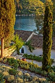 KOULOURA, CORFU, GREECE: DESIGNER PAUL BANGAY: TOP TERRACE, WATER FEATURE, LAWN, CHURCH, SUNRISE