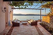 KOULOURA, CORFU, GREECE: DESIGNER PAUL BANGAY: SEA TERRACE, SEATS, TABLE, SUNRISE