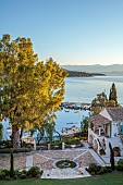 KOULOURA, CORFU, GREECE: DESIGNER PAUL BANGAY: VIEW OF COURTYARD AND HARBOUR FROM TOP TERRACE