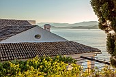 KOULOURA, CORFU, GREECE: DESIGNER PAUL BANGAY: VINES DRAPED OVER PERGOLA, ROOF OF VILLA