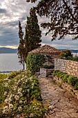 KOULOURA, CORFU, GREECE: DESIGNER PAUL BANGAY: WALLS, PATH, POOL HOUSE, ROSES, ROSA ICEBERG