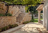 KOULOURA, CORFU, GREECE: DESIGNER PAUL BANGAY: TERRACE, WALLS, STEPS, PERGOLA, VINES