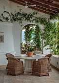 KOULOURA, CORFU, GREECE: DESIGNER PAUL BANGAY: COURTYARD, TERRACE, TABLE, CHIARS, ORCHID, MIRROR