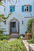 KOULOURA, CORFU, GREECE: DESIGNER PAUL BANGAY: OLD ARCHWAY, STAR JASMINE, TRACHELOSPERMUM JASMINOIDES