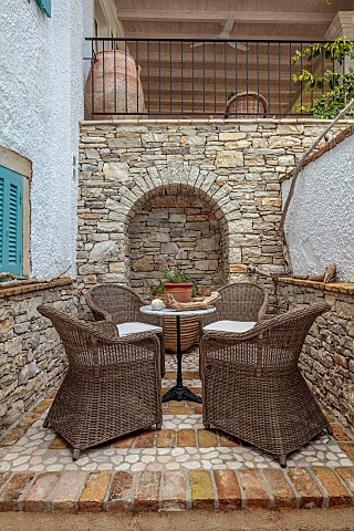 KOULOURA_CORFU_GREECE_DESIGNER_PAUL_BANGAY_PATIO_COURTYARD_DRIFTWOOD_BLUE_SHUTTERS_CHAIRS_TABLE_WALL