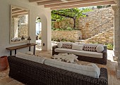 KOULOURA, CORFU, GREECE: DESIGNER PAUL BANGAY: OUTDOOR LIVING, SETTEES, TABLE, WALLS, STEPS, VINE, PERGOLA, LAWN, MIRROR