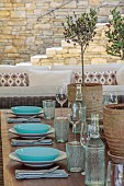 KOULOURA, CORFU, GREECE: DESIGNER PAUL BANGAY: OUTDOOR LIVING, TABLE AND CHAIRS, TERRACE, PATIO, OLIVES IN TERRACOTTA CONTAINERS