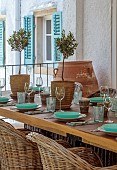 KOULOURA, CORFU, GREECE: DESIGNER PAUL BANGAY: OUTDOOR LIVING, TABLE AND CHAIRS, TERRACE, PATIO, OLIVES IN TERRACOTTA CONTAINERS