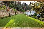 KOULOURA, CORFU, GREECE: DESIGNER PAUL BANGAY: LAWN, TERRACING, WALLS, TERRACOTTA CONTAINERS, CHURCH, BORROWED LANDSCAPE