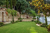 KOULOURA, CORFU, GREECE: DESIGNER PAUL BANGAY: LAWN, TERRACING, WALLS, TERRACOTTA CONTAINERS, CHURCH, WATER FEATURE, BORROWED LANDSCAPE