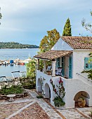 KOULOURA, CORFU, GREECE: DESIGNER PAUL BANGAY: VIEW OF COURTYARD AND HARBOUR FROM UPPER TERRACE