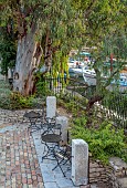 KOULOURA, CORFU, GREECE: DESIGNER PAUL BANGAY: METAL SEATS AND TABLES IN COURTYARD