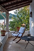 KOULOURA, CORFU, GREECE: DESIGNER PAUL BANGAY: CHAIR AND TABLE ON TERRACE