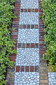 KOULOURA, CORFU, GREECE: DESIGNER PAUL BANGAY: DECORATIVE COBBLE FLOORING, PATH, STAR JASMINE, TRACHELOSPERMUM JASMINOIDES