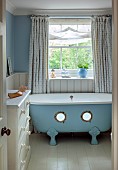 PRIORS MARSTON, WARWICKSHIRE, THE MANOR HOUSE:CHILDRENS BATHROOM, SEASIDE THEMED, FREESTANDING BLUE BATH WITH PORTHOLES