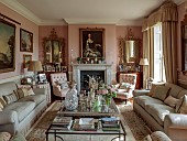 PRIORS MARSTON, WARWICKSHIRE, THE MANOR HOUSE: THE SITTING ROOM, PINK, SOFAS, CENTRAL GLASS COFFEE TABLE