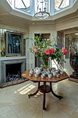 PRIORS MARSTON, WARWICKSHIRE, THE MANOR HOUSE: ENTRANCE HALL, LANTERN CEILING, FIREPLACE, CENTRAL TABLE WITHDISPLAY OF FLOWERS FROM THE WALLED GARDEN