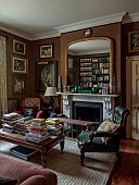 PRIORS MARSTON, WARWICKSHIRE, THE MANOR HOUSE: THE LIBRARY IN CHOCOLATE BROWN, GREEN CHAIR, MIRROR