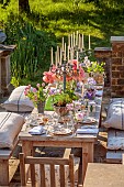 PRIORS MARSTON, WARWICKSHIRE, THE MANOR HOUSE: LONG WOODEN TABLE SET FOR DINNER ON BALCONY BESIDE THE LAKE, MAY
