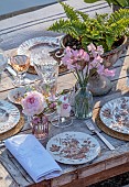PRIORS MARSTON, WARWICKSHIRE, THE MANOR HOUSE: LONG WOODEN TABLE SET FOR DINNER ON BALCONY BESIDE THE LAKE, MAY