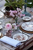 PRIORS MARSTON, WARWICKSHIRE, THE MANOR HOUSE: LONG WOODEN TABLE SET FOR DINNER ON BALCONY BESIDE THE LAKE, MAY