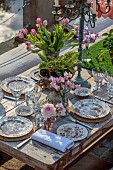 PRIORS MARSTON, WARWICKSHIRE, THE MANOR HOUSE: LONG WOODEN TABLE SET FOR DINNER ON BALCONY BESIDE THE LAKE, MAY