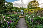 PRIORS MARSTON, WARWICKSHIRE, THE MANOR HOUSE: MAY, THE KITCHEN GARDEN, VEGETABLE GARDEN, POTAGER, PEONIES, PATH, GREENHOUSE, IRIS, WALLED GARDEN, CUTTING GARDEN