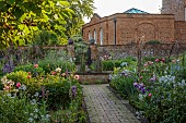 PRIORS MARSTON, WARWICKSHIRE, THE MANOR HOUSE: MAY, THE KITCHEN GARDEN, VEGETABLE GARDEN, POTAGER, PEONIES, PATH, IRIS, WALLED GARDEN, CUTTING GARDEN