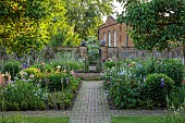 PRIORS MARSTON, WARWICKSHIRE, THE MANOR HOUSE: MAY, THE KITCHEN GARDEN, VEGETABLE GARDEN, POTAGER, PEONIES, PATH, IRIS, WALLED GARDEN, CUTTING GARDEN