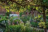 PRIORS MARSTON, WARWICKSHIRE, THE MANOR HOUSE: MAY, THE KITCHEN GARDEN, VEGETABLE GARDEN, POTAGER, PEONIES, PATH, IRIS, WALLED GARDEN, CUTTING GARDEN